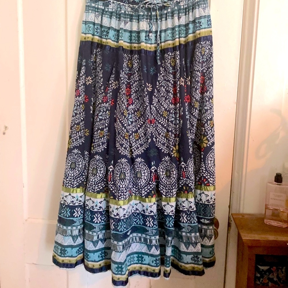 Blue floral print cotton maxi skirt. Layered w/satin ribbon detail. 100% cotton.